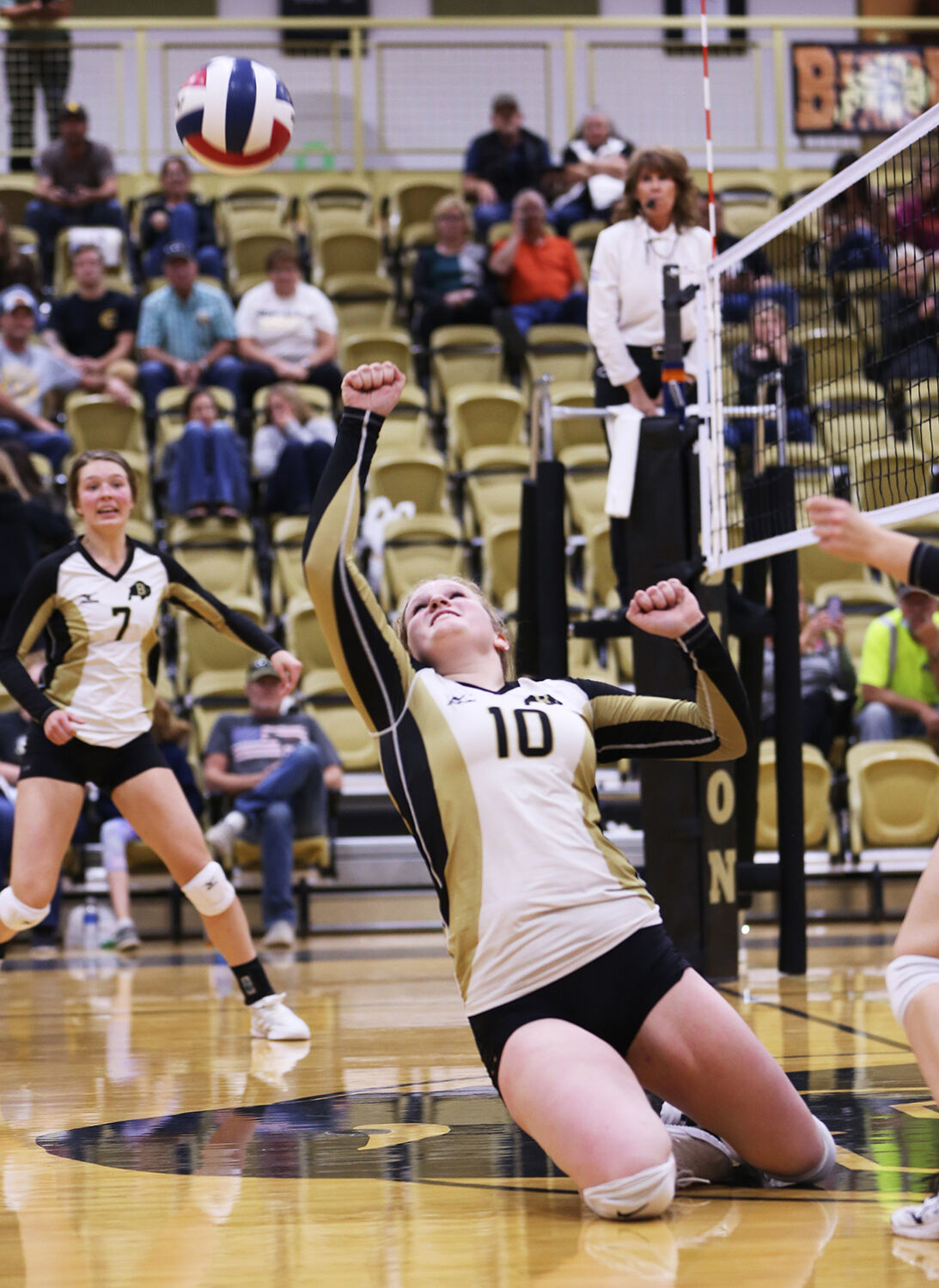 Tessa Taylor throws her fist up in the air to save a tipped ball